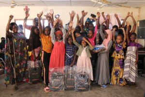 Group of girls receiving stationary from IGNITEe Association pour un monde meilleur in Southern Burkina Faso